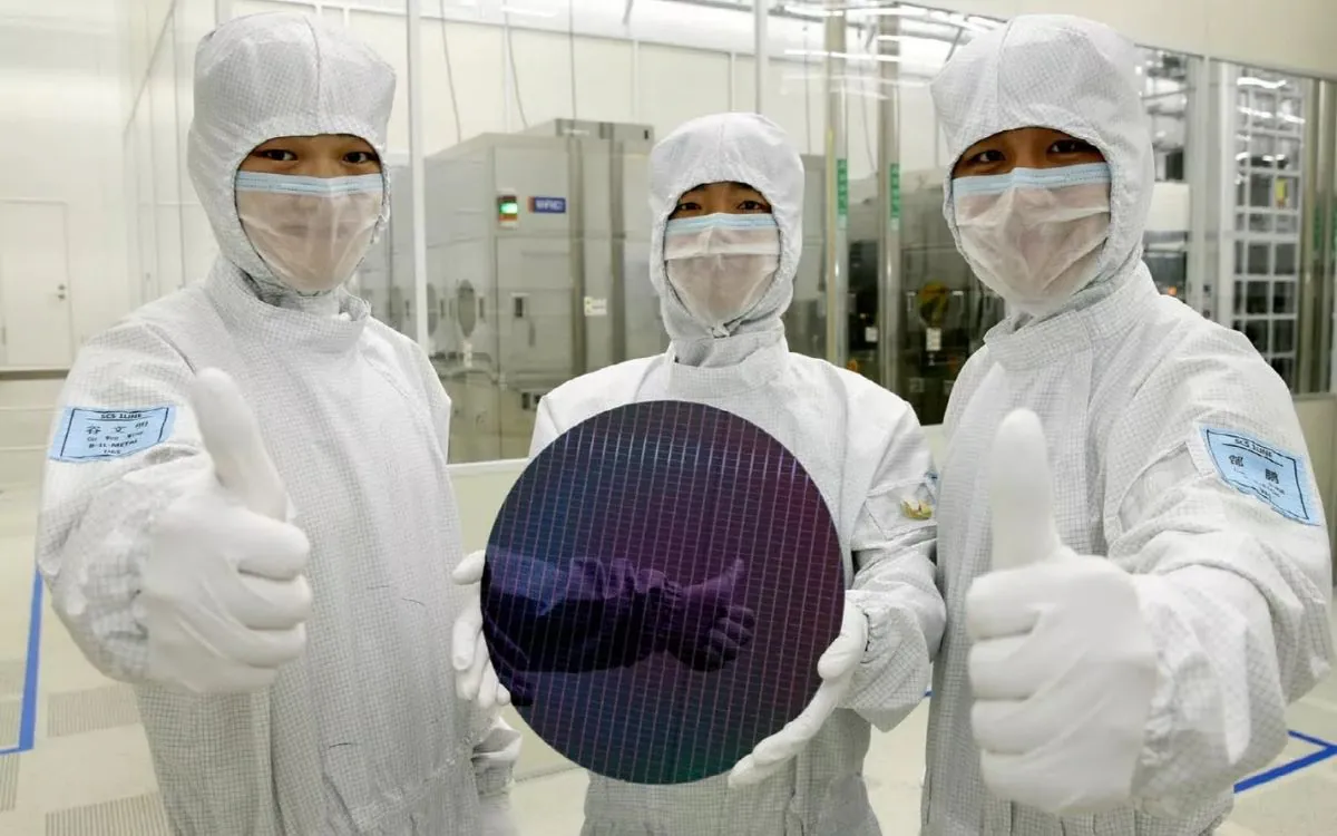 Technicians show wafer for chip manufacturing