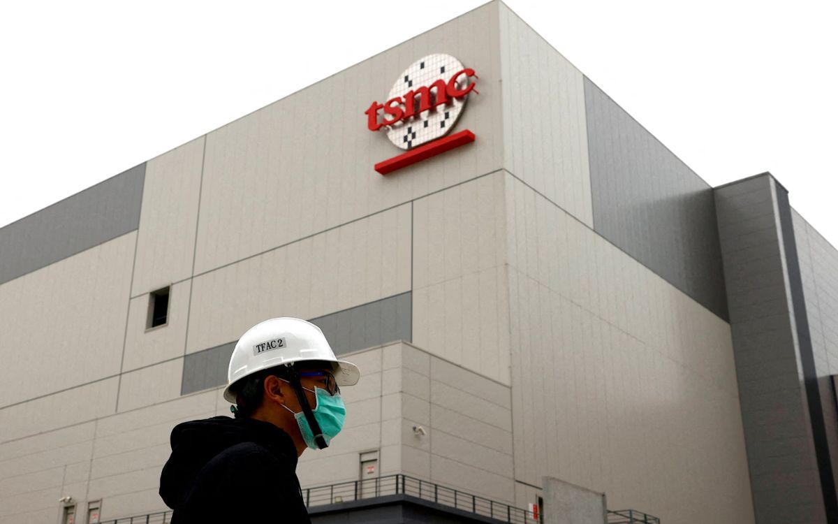 Prédio da TSMC com operário passando na frente