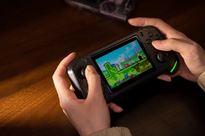 Portátil na mão de uma pessoa jogando